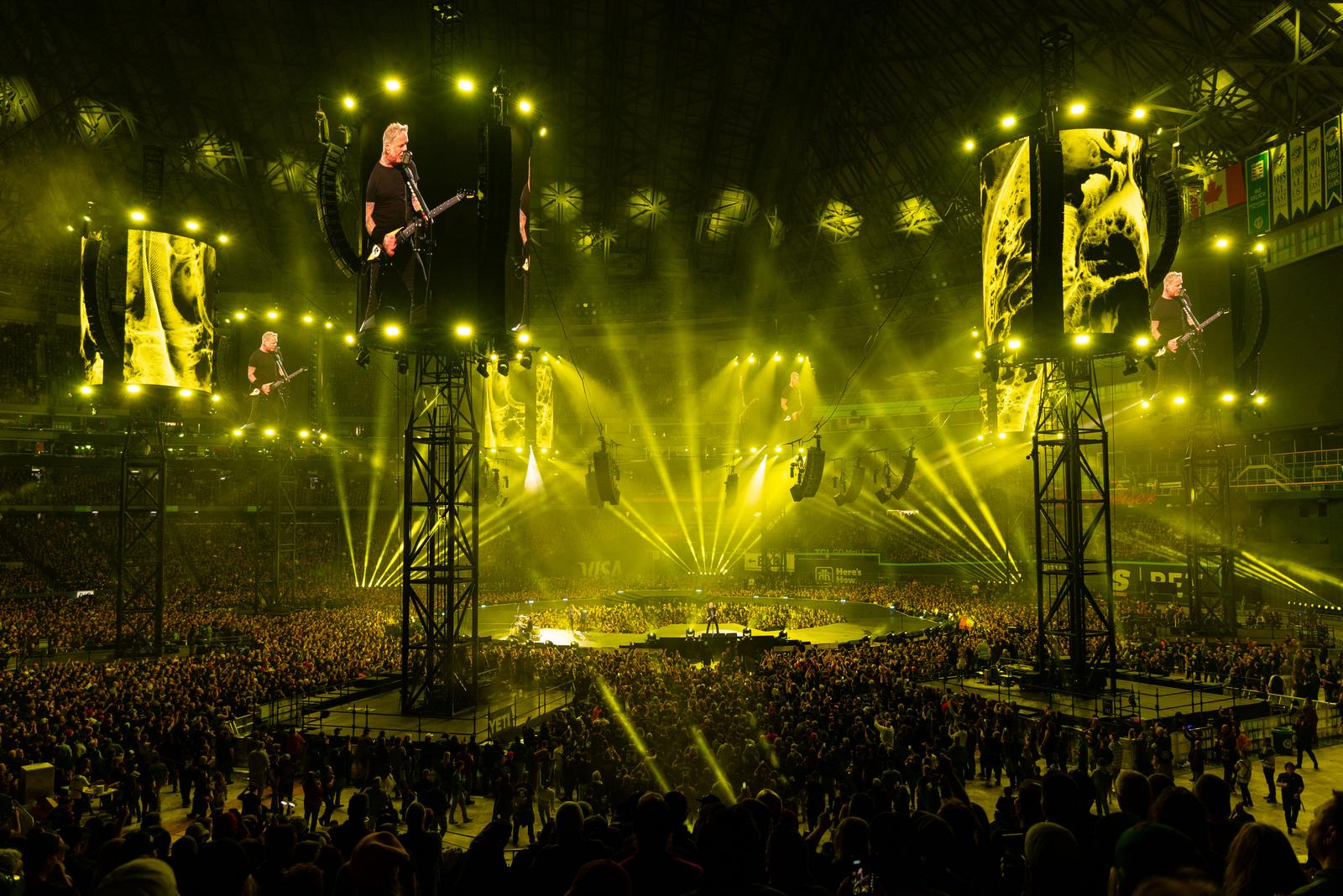 Bright yellow beams sweeping across Metallica's packed M72 stadium stage